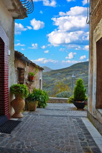 A vertical shot of a beautiful narrow street in Fornelli village in Molise, Italy on a sunny day