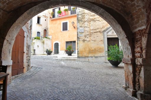 A narrow street with arched entrances in the village of Fornelly,  Molise region, Italy.