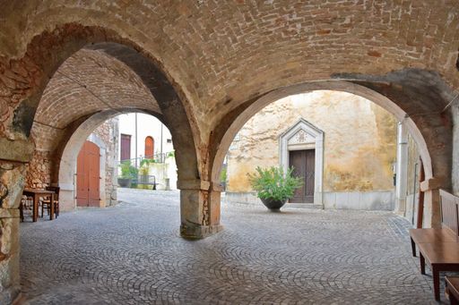 A narrow street with arched entrances in the village of Fornelly,  Molise region, Italy.