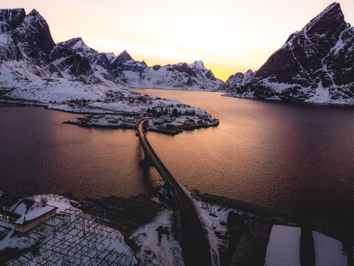 An aerial shot of Lofoten Island mountains during sunset in winter