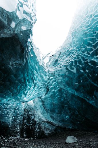A Vertical shot of a blue crystal ice cave in Iceland