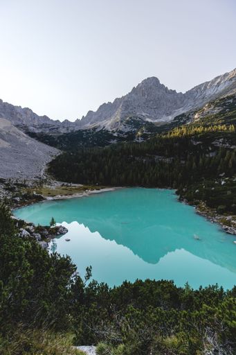 A beautiful view of Lake Sorapis in Italy under bright sky with reflecting water