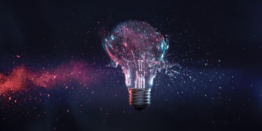 A high-speed shot of explosion of a tungsten filament bulb on a black background - obsolete energy concept