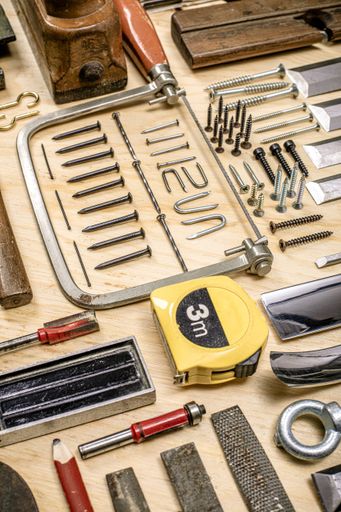 A high angle shot of different types of carpenter tools on the table