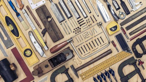 A high angle shot of different types of carpenter tools on the table