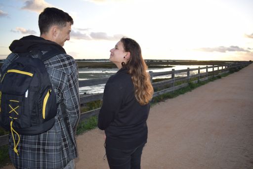 A beautiful couple visiting Faro, Portugal during a bright sunset