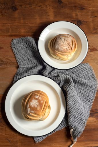 A vertical top view of breads in artisan style plates on wooden table