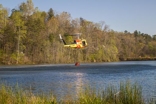 A fire helicopter scooping up water from lake