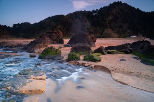 stone formations in the beach of Laga, basque country at sunset