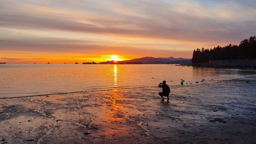 photographer silhouette capturing the sunset. Sharing hapiness concept.