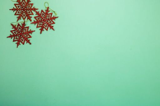 A top view of glittery snowflakes for Christmas isolated on the green background
