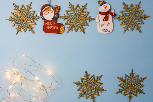 A light blue Christmas composition background with ornaments and decorations with copy space