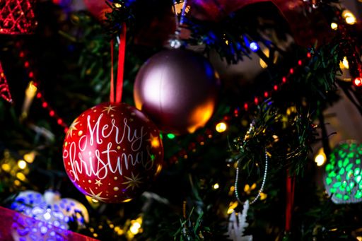 A soft focus of sparkly Christmas baubles hanging from a tree
