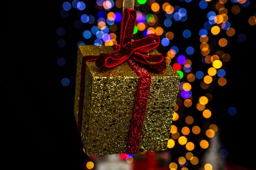 A soft focus of a glittery Christmas decoration  against bokeh lights background