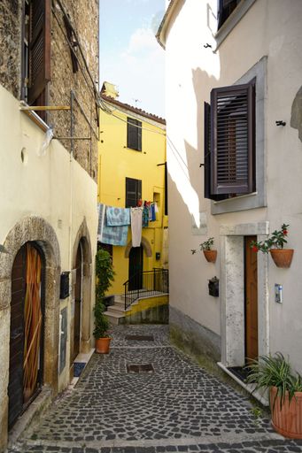 A narrow street among the old houses of Giuliano di Roma, a village in the Lazio region of Italy