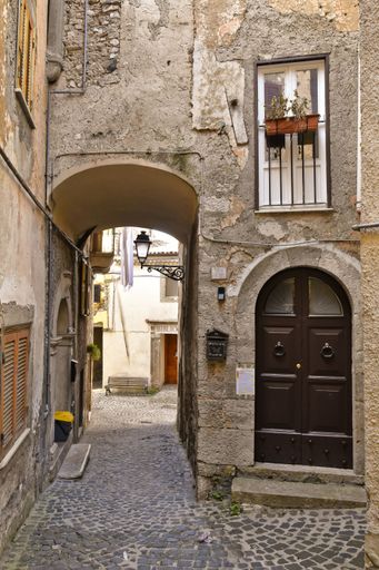 A narrow street among the old houses of Giuliano di Roma, a village in the Lazio region of Italy