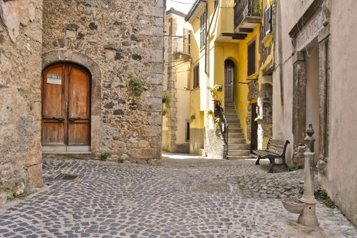 A narrow street among the old houses of Giuliano di Roma, a village in the Lazio region of Italy