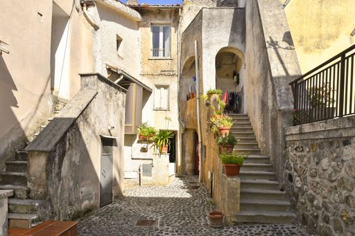 A narrow street among the old houses of Giuliano di Roma, a village in the Lazio region of Italy