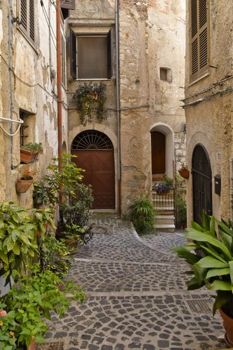 A narrow street among the old houses of Giuliano di Roma, a village in the Lazio region of Italy
