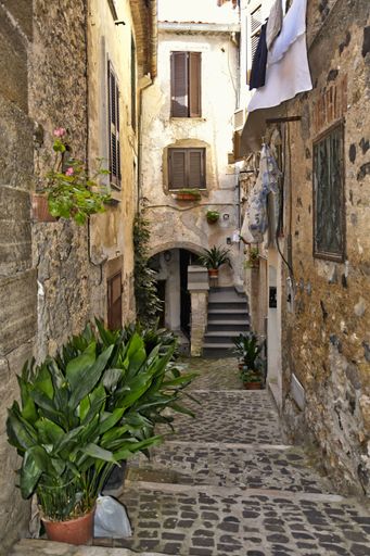 A narrow street among the old houses of Giuliano di Roma, a village in the Lazio region of Italy
