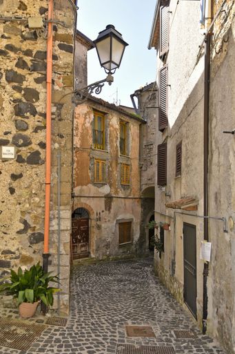 A narrow street among the old houses of Giuliano di Roma, a village in the Lazio region of Italy
