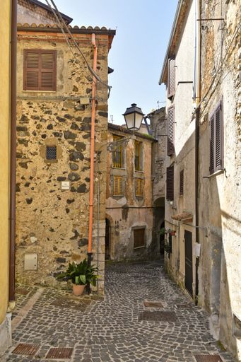 A narrow street among the old houses of Giuliano di Roma, a village in the Lazio region of Italy