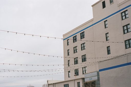 A closeup of a white stone building facade against a cloudy sky