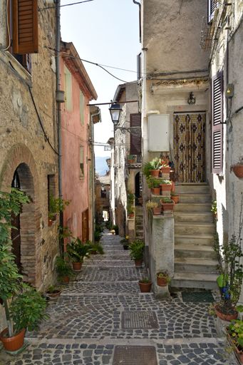 A narrow street between the old houses of the medieval village of Giuliano di Roma