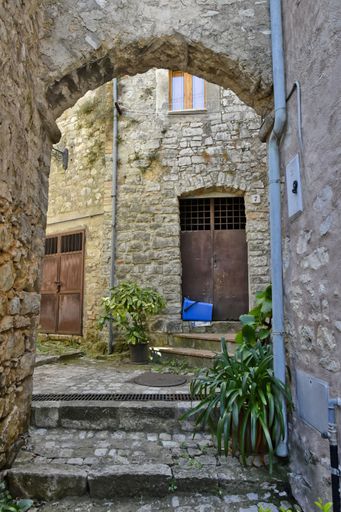 A narrow street among the old houses of Lenola, a medieval village in the Lazio region, Italy.