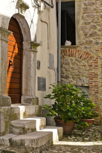 A narrow street among the old houses of Lenola, a medieval village in the Lazio region, Italy.