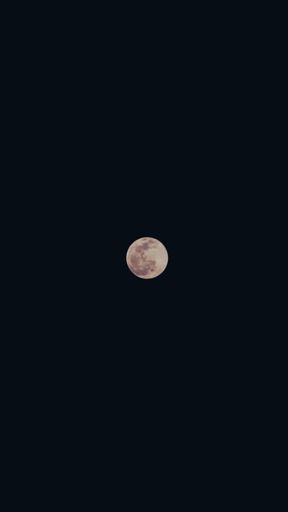 A view of the full moon in the dark sky