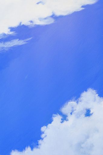 A closeup shot of a painting of a blue sky with white clouds