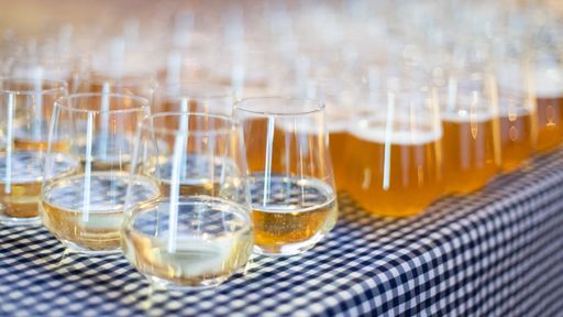 A closeup shot of many glasses of beer on the table