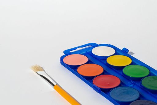 A closeup shot of a watercolor palette isolated on a white background
