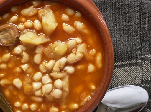 A closeup shot of a bowl of Spanish Asturian fabada on a table