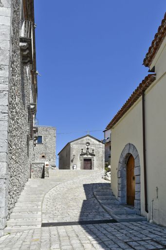 A vertical of a narrow street and an old church in Aieta village, the Calabria region, Italy