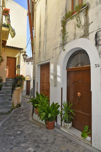 A vertical of a narrow street and old houses in Aieta village, the Calabria region, Italy