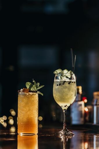 A vertical shot of refreshing cocktails on a bar