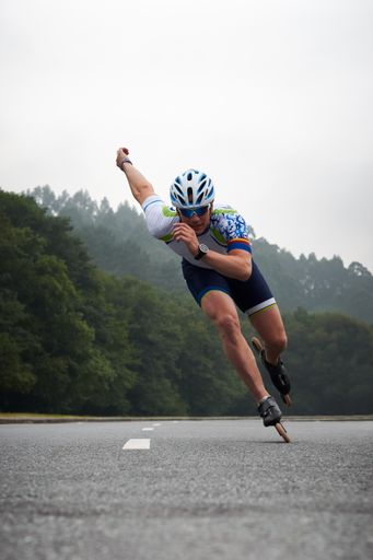 A vertical shot of a male skater doing a marathon