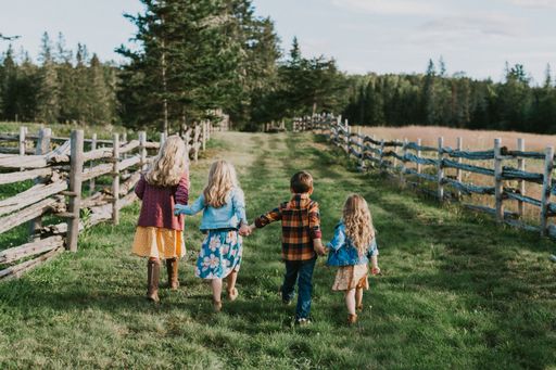 A back view of four siblings in the Doak House area, New Brunswick