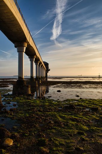 A vertical shot of columns of the Bembridge Lifeboat Station gangway on the Isle of Wight at sunset