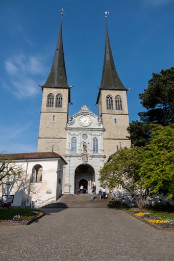 A vertical shot of an exterior of the Church of St. Leodegar in Lucerne, Switzerland