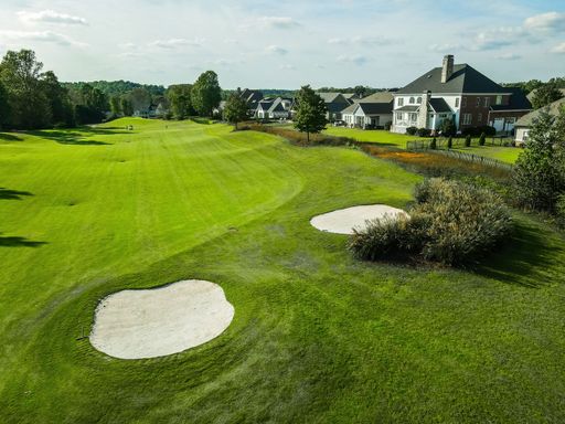 View of trees, lawns and golf villas in a golf course on a sunny day