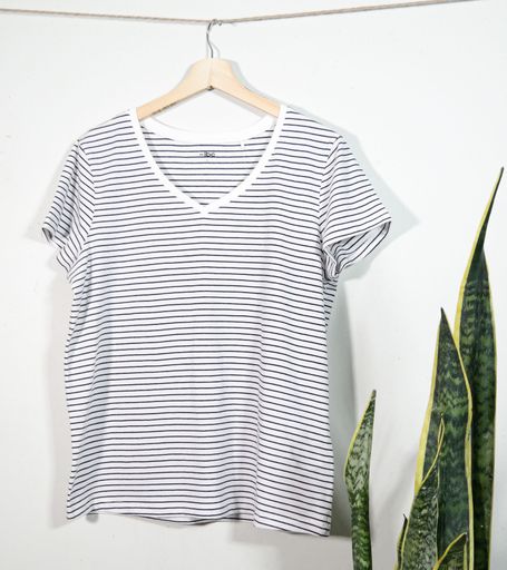 A closeup of a stripped t-shirt on a white background