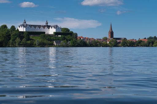 Beautiful view from great ploner ploener lake to plon castle and church Nikolaikirche in Germany, Ploen