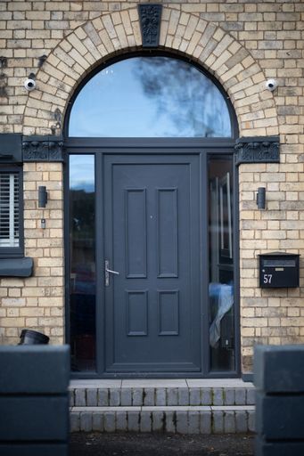 A vertical shot of a dark blue door of a residential building