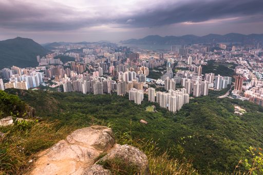 The view of the Kowloon walled city from Lion Rock hill under a stormy cloudy sky in Hong Kong, China