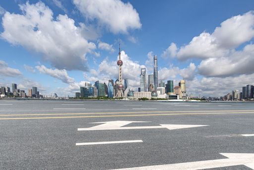empty asphalt road of modern cityscape and skyline of shanghai in day time. copy space for car advertisement.