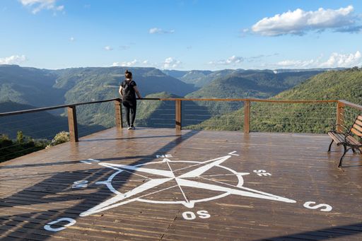 Nova Petropolis, Rio Grande do Sul, Brazil - Apr 19th, 2022: Young woman looking at mountains at Parada da Torre Viewpoint, Cai River Valley