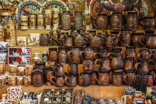 A closeup of Various vintage souvenir ceramic products on a market stall